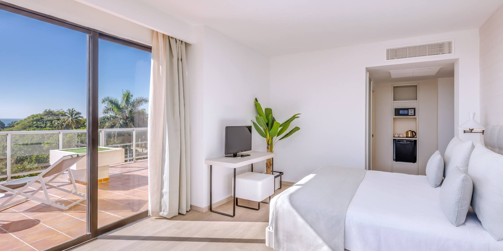 a room with a bed and a television