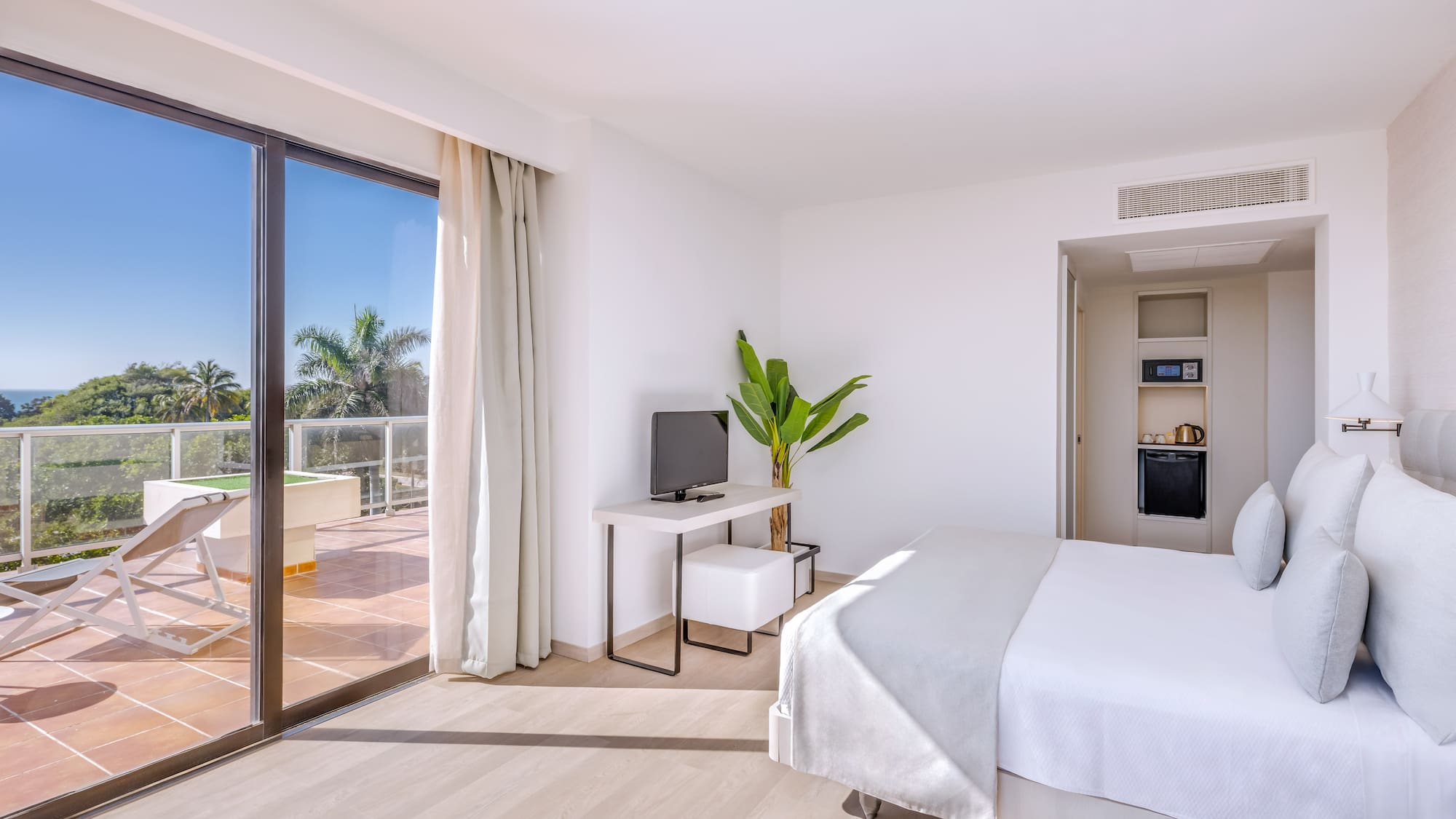 a room with a bed and a television