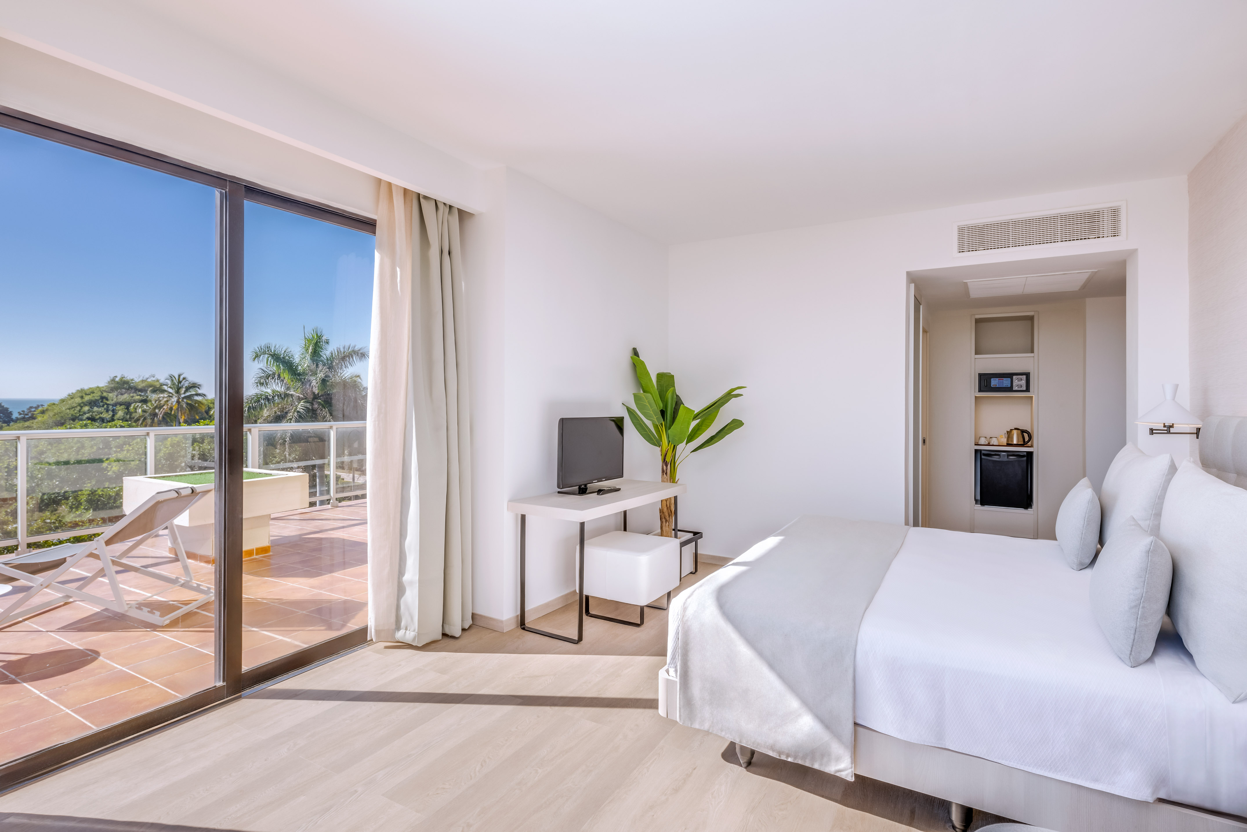 a room with a bed and a television