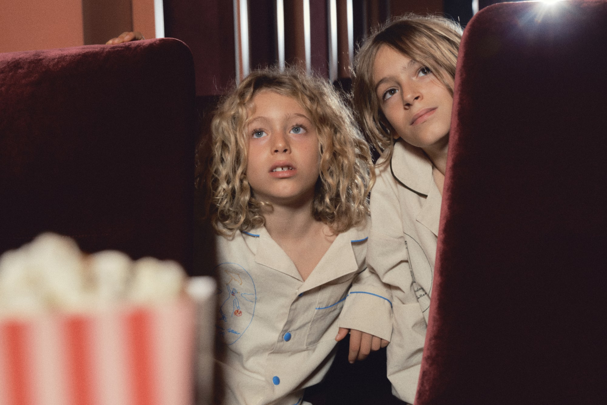 two children sitting in a theater