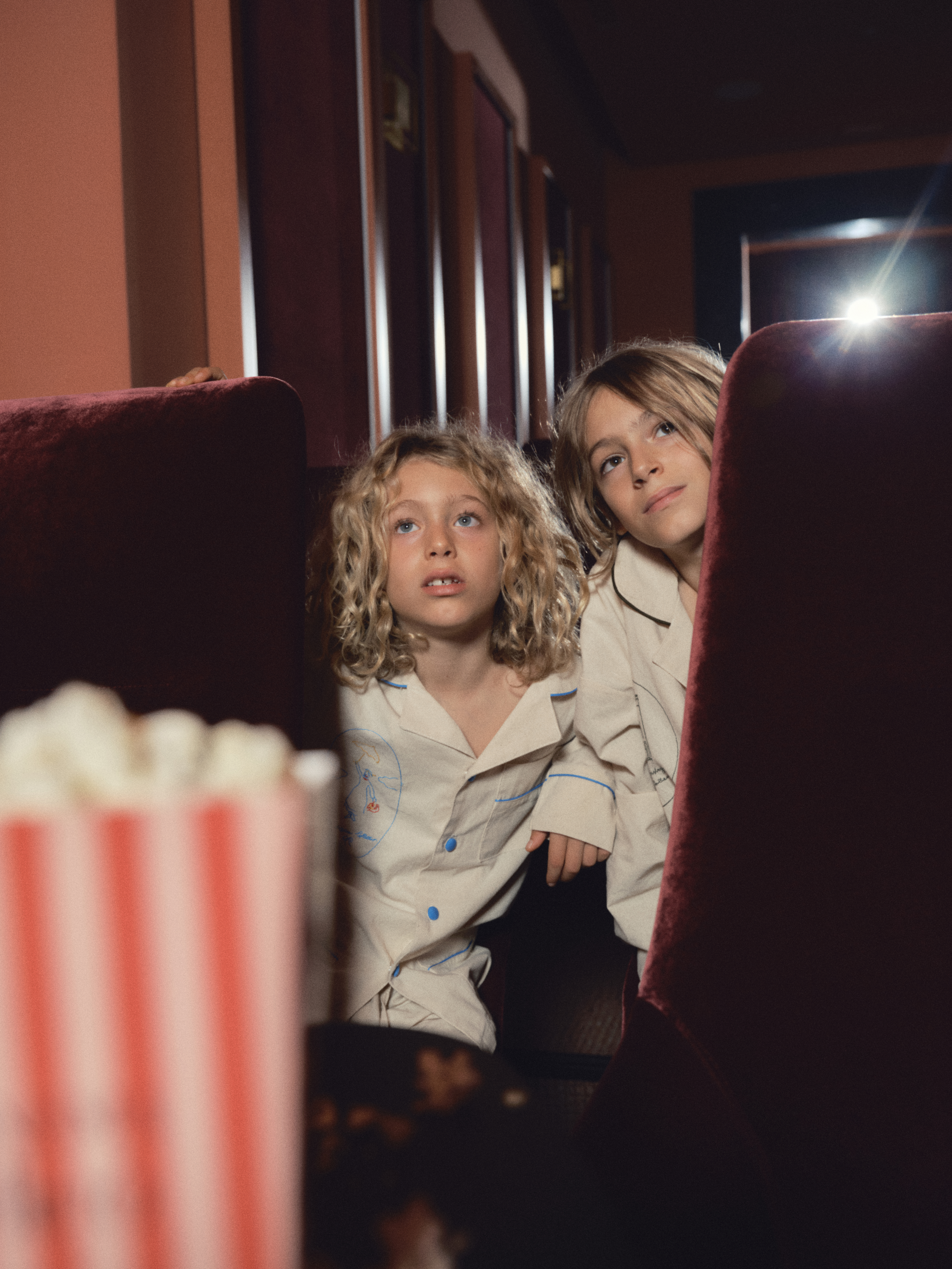 two children sitting in a theater