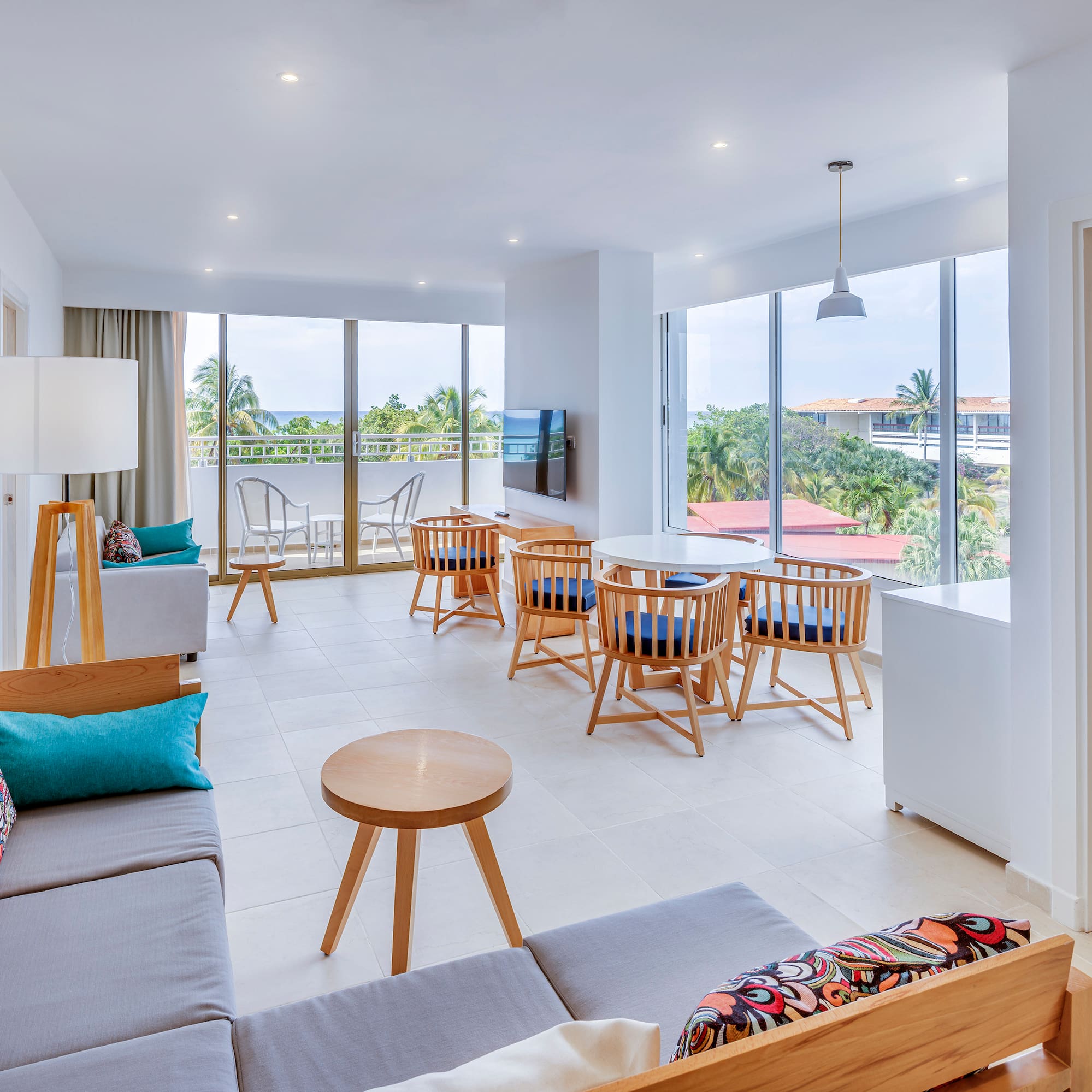 a room with a couch and chairs and a table