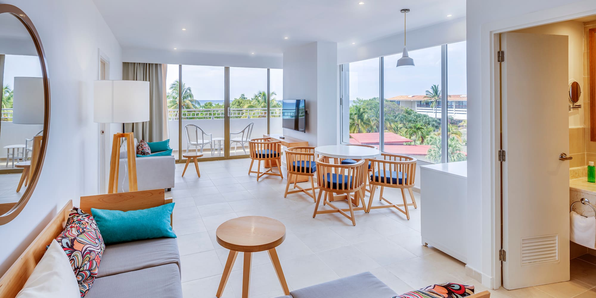 a room with a couch and chairs and a table