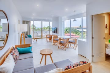 a room with a couch and chairs and a table