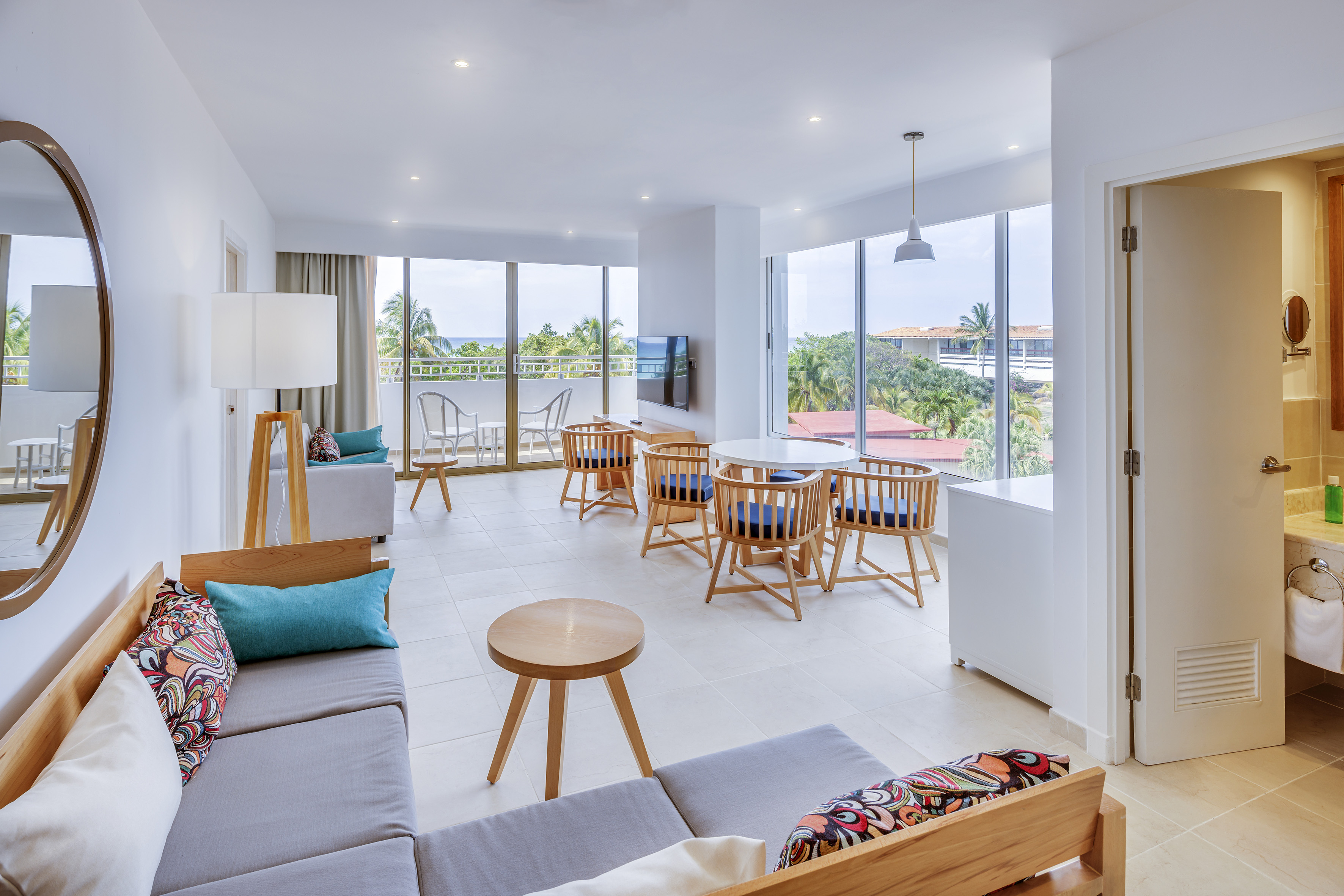 a room with a couch and chairs and a table