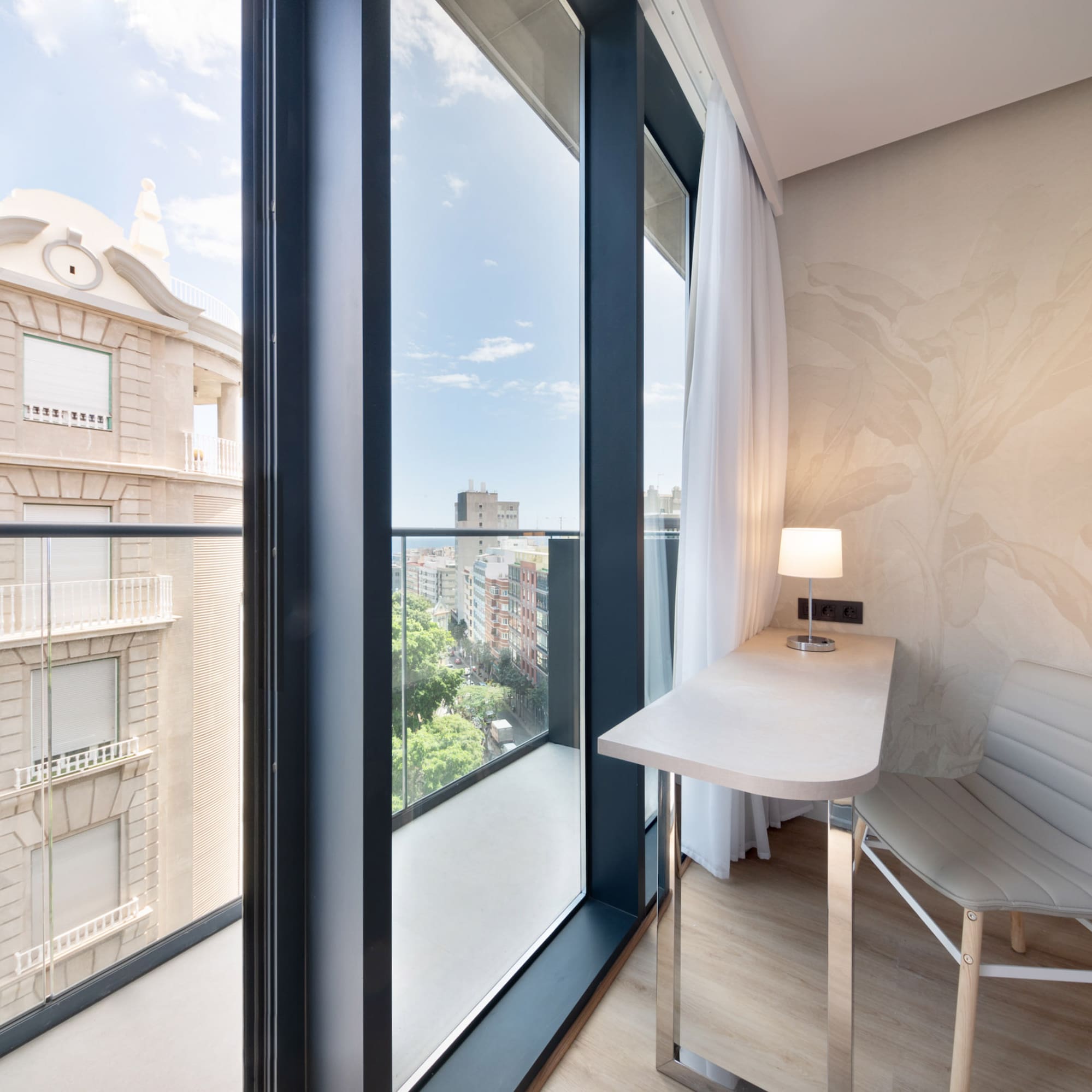 a room with a desk and chair and a window