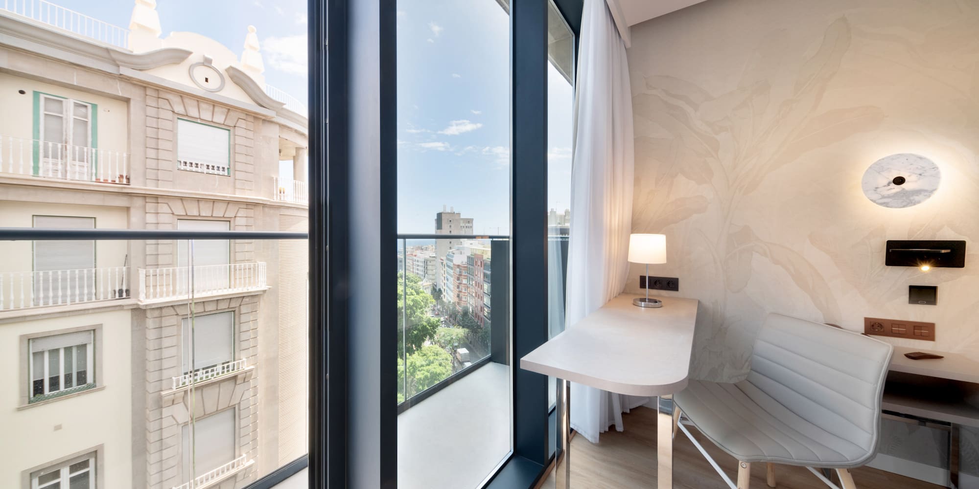 a room with a desk and chair and a window