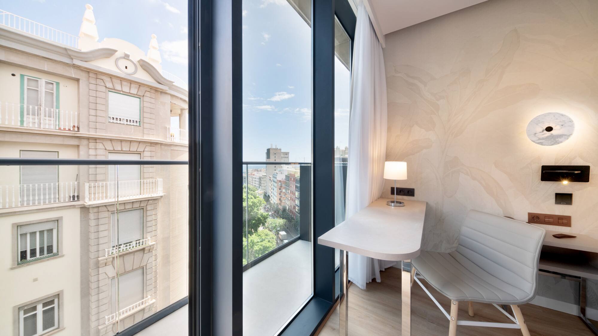 a room with a desk and chair and a window