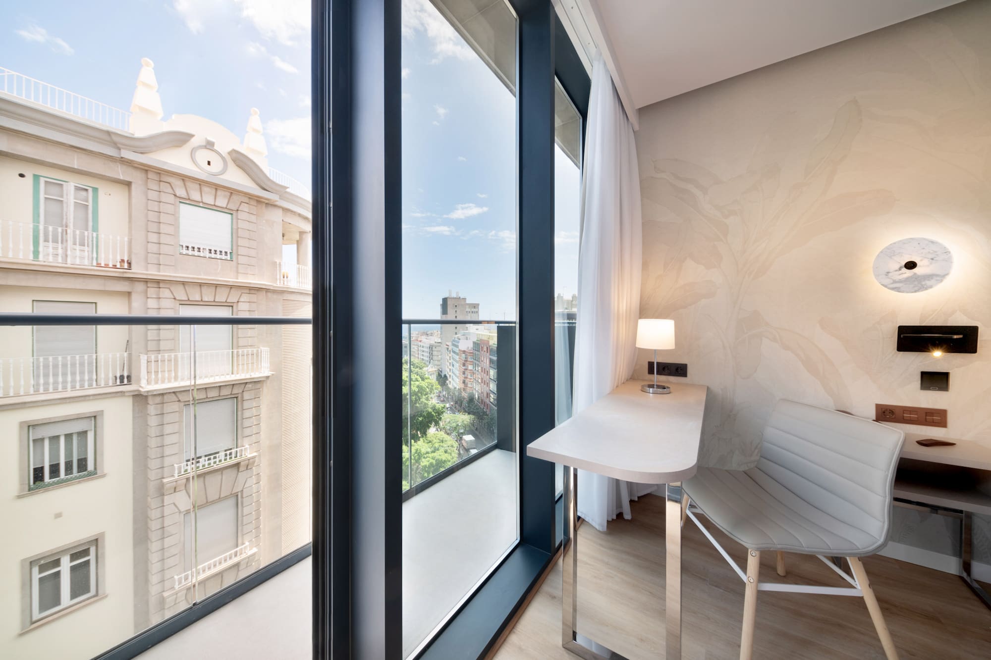 a room with a desk and chair and a window