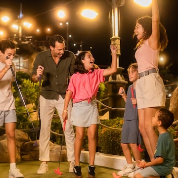 a group of people holding golf clubs