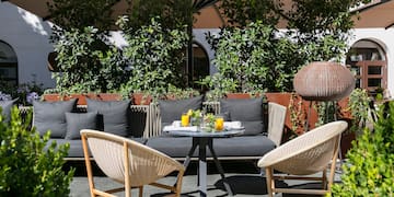 a patio area with a table and chairs