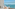 Luxury balcony lounge with panoramic ocean views and distant island.
