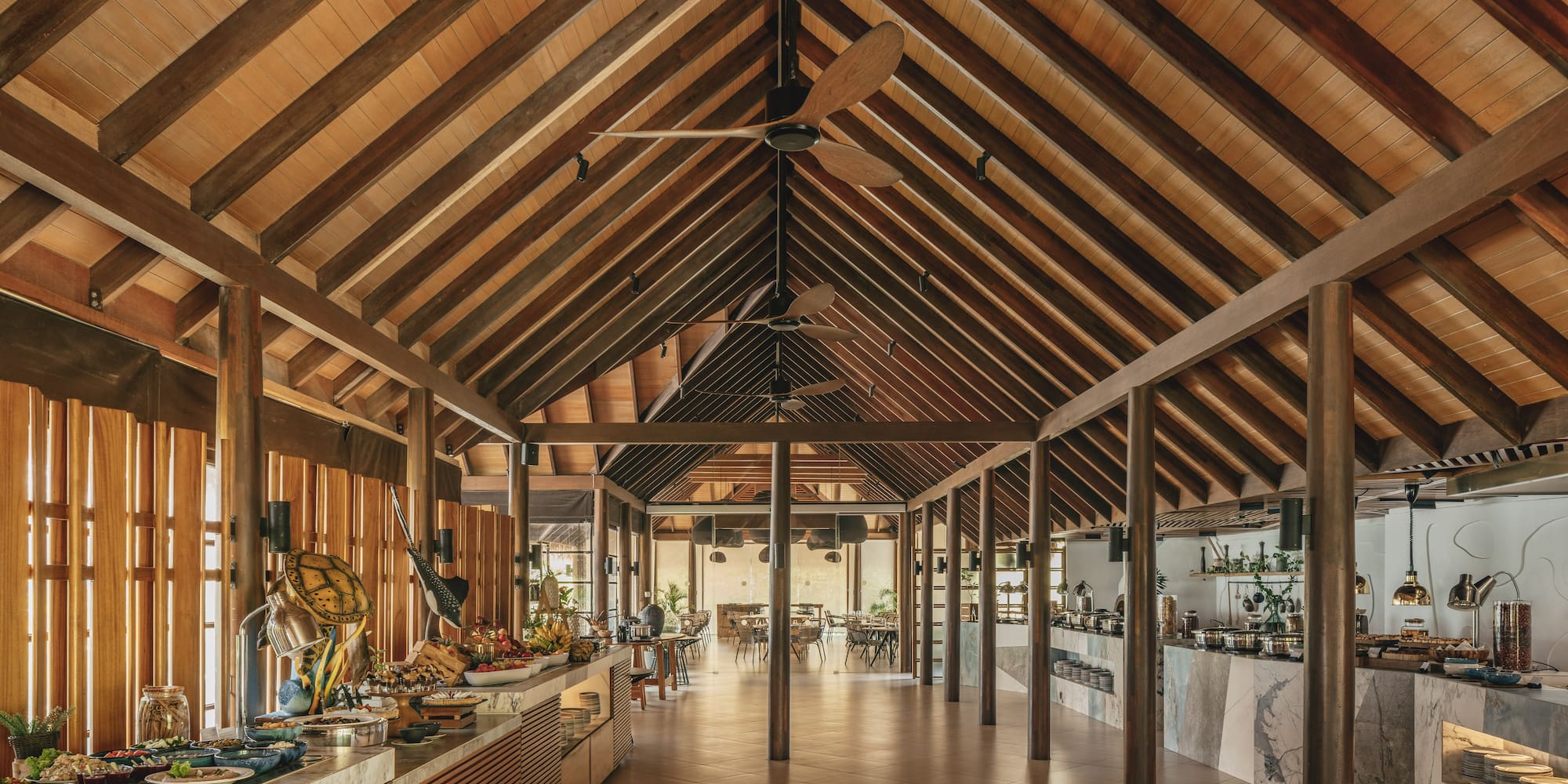a room with a wood ceiling and a table with food on it
