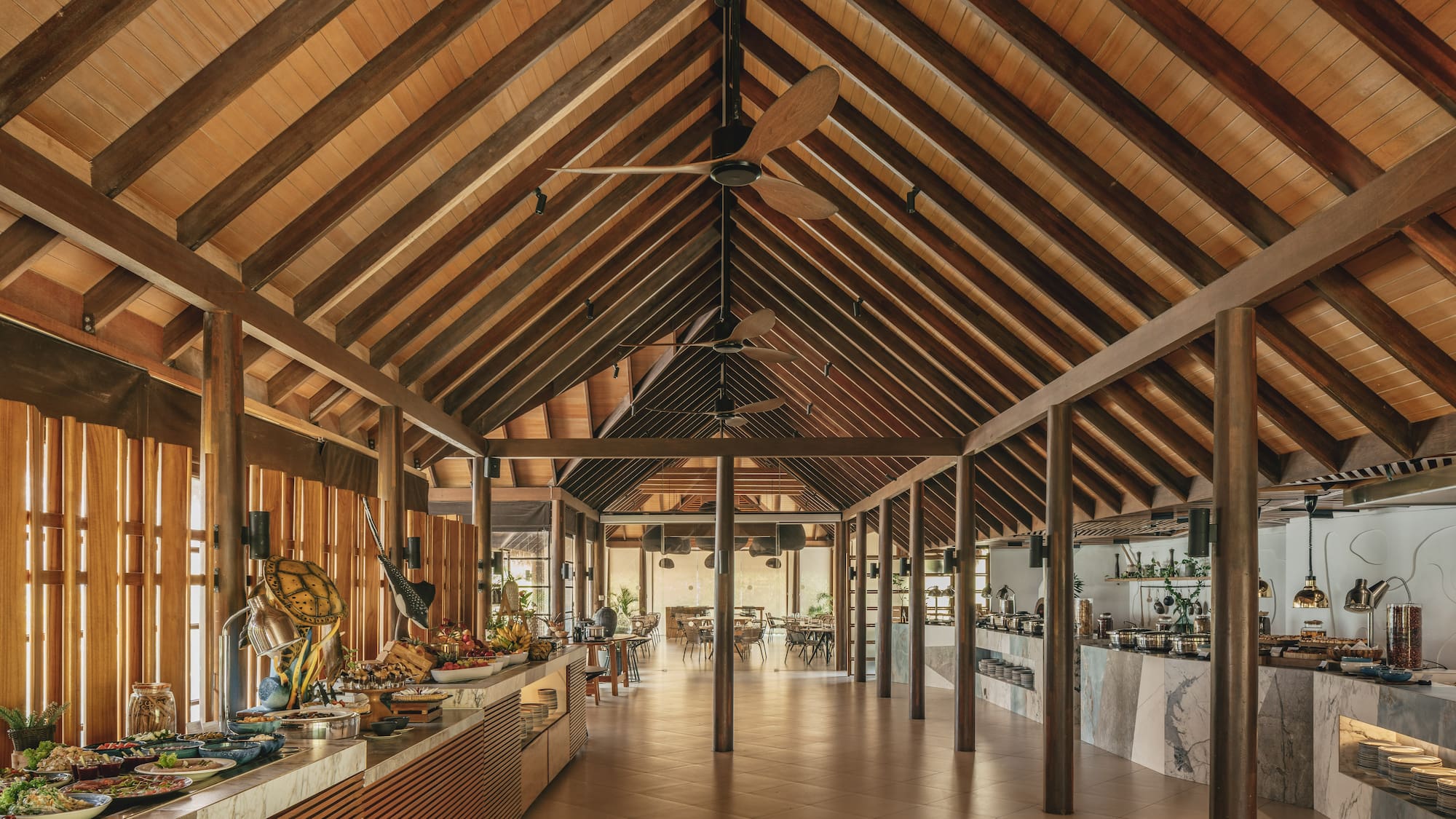 a room with a wood ceiling and a table with food on it
