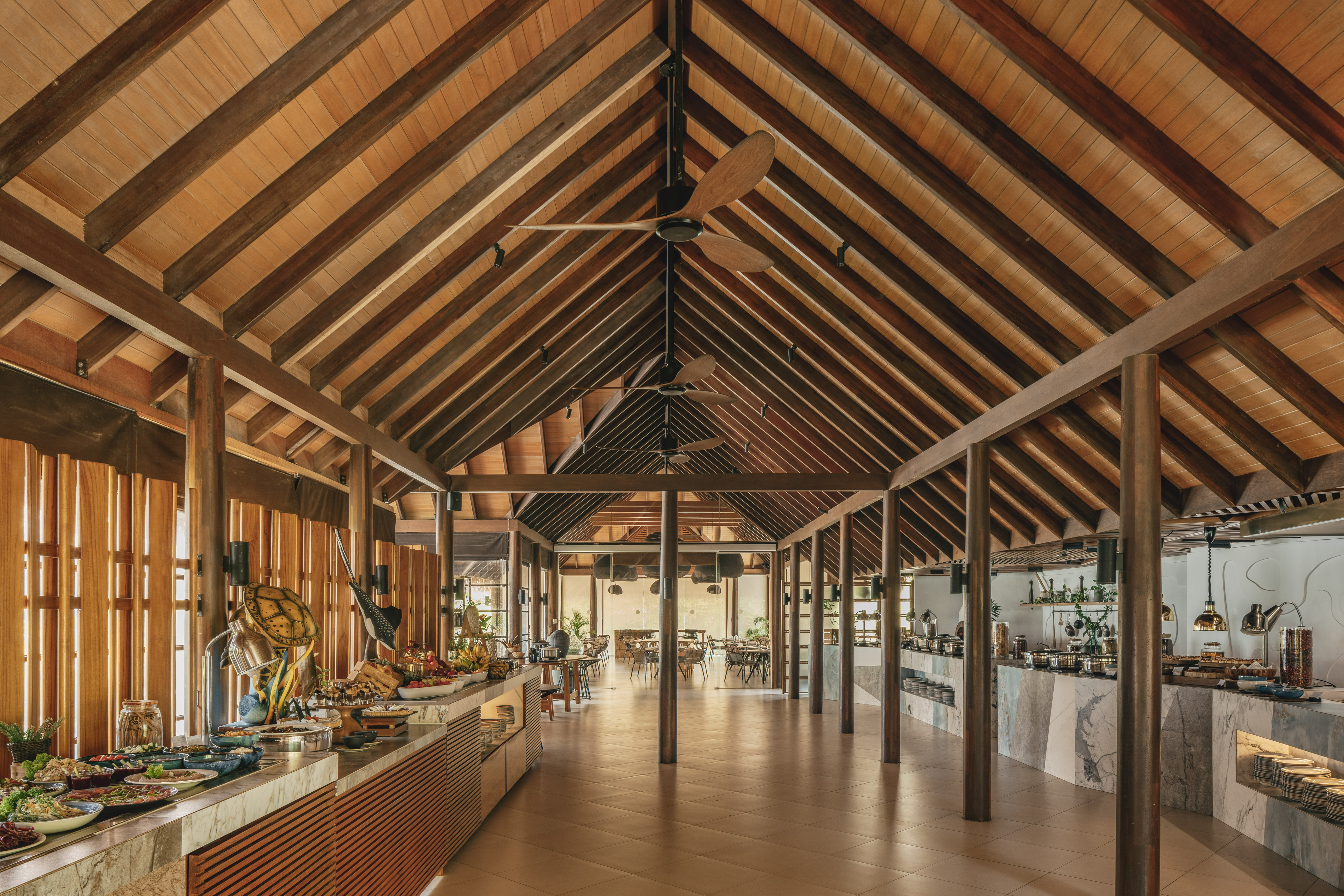a room with a wood ceiling and a table with food on it