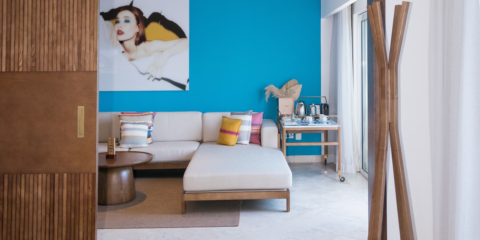 a room with a couch and a blue wall