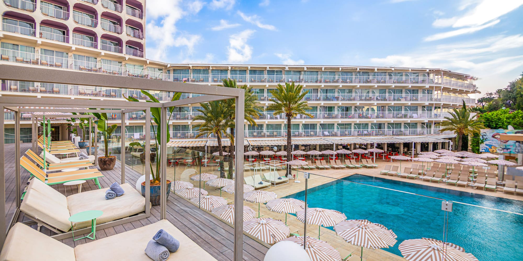 a pool with umbrellas and lounge chairs