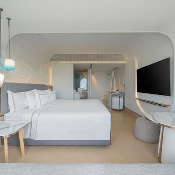 a room with a bed and a television