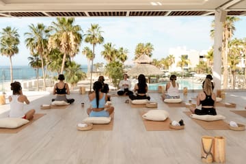 a group of people sitting on mats