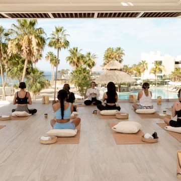 a group of people sitting on mats