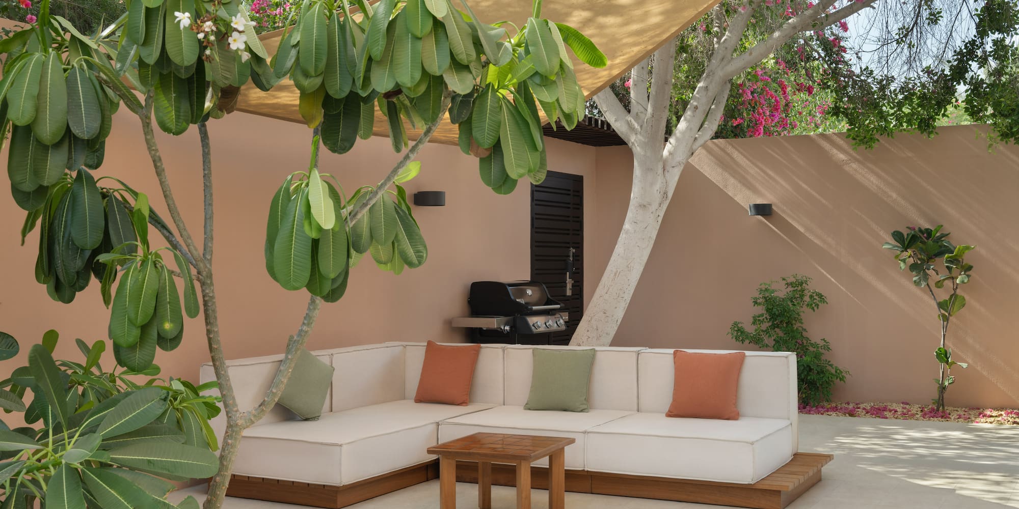 a couch and table under a tree