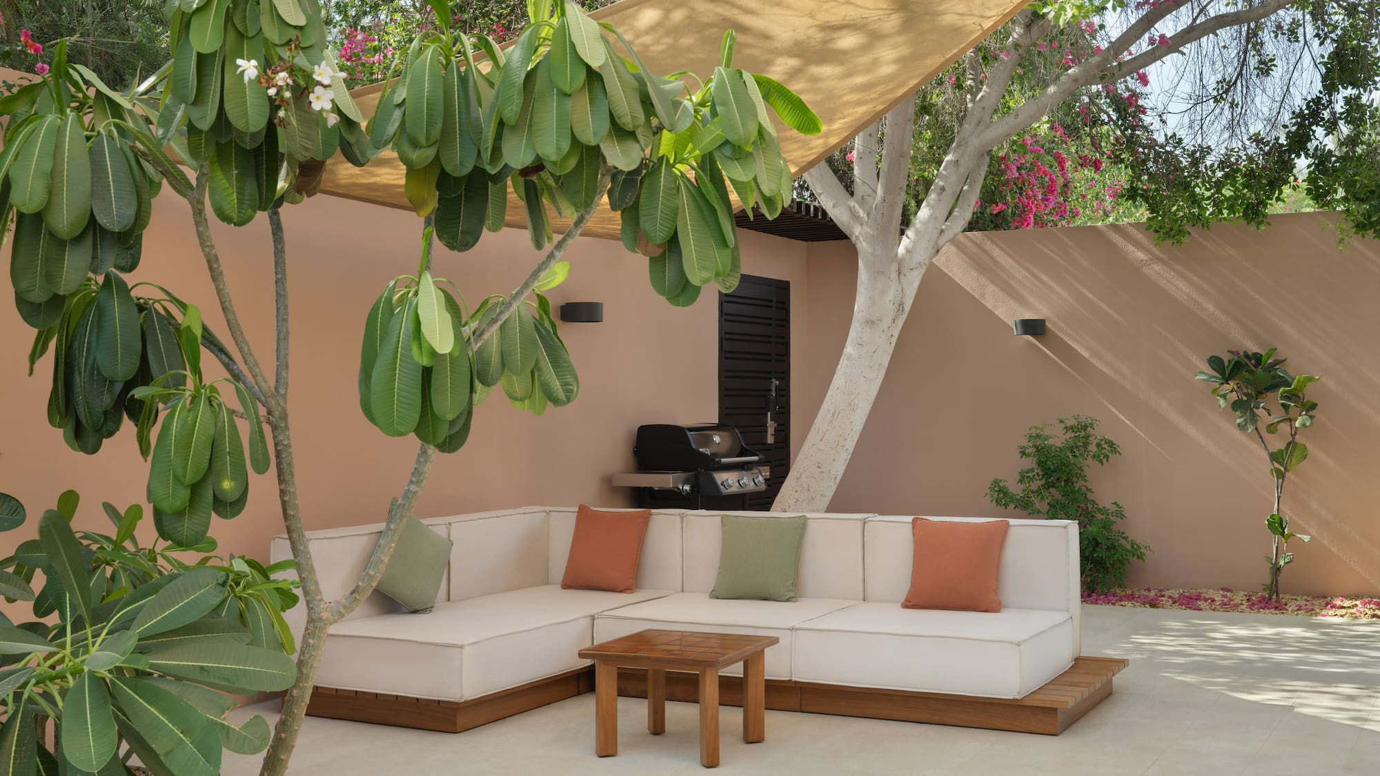 a couch and table under a tree