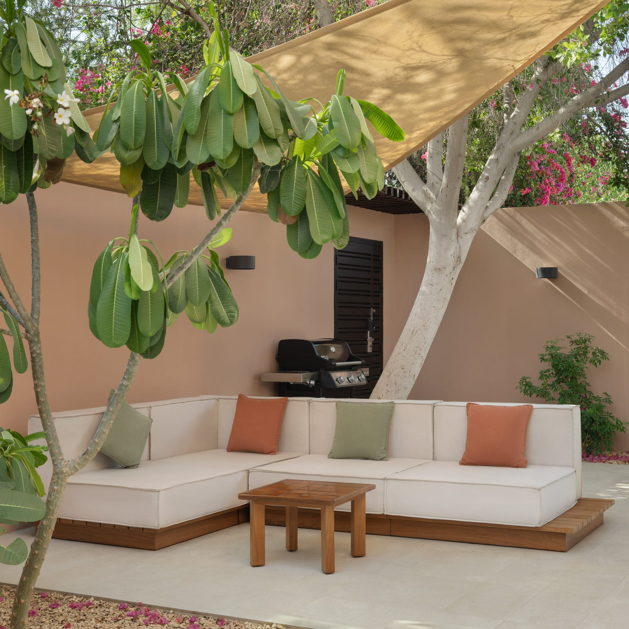 a couch and table under a tree