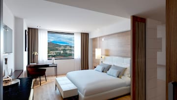 a bedroom with a desk and a bed