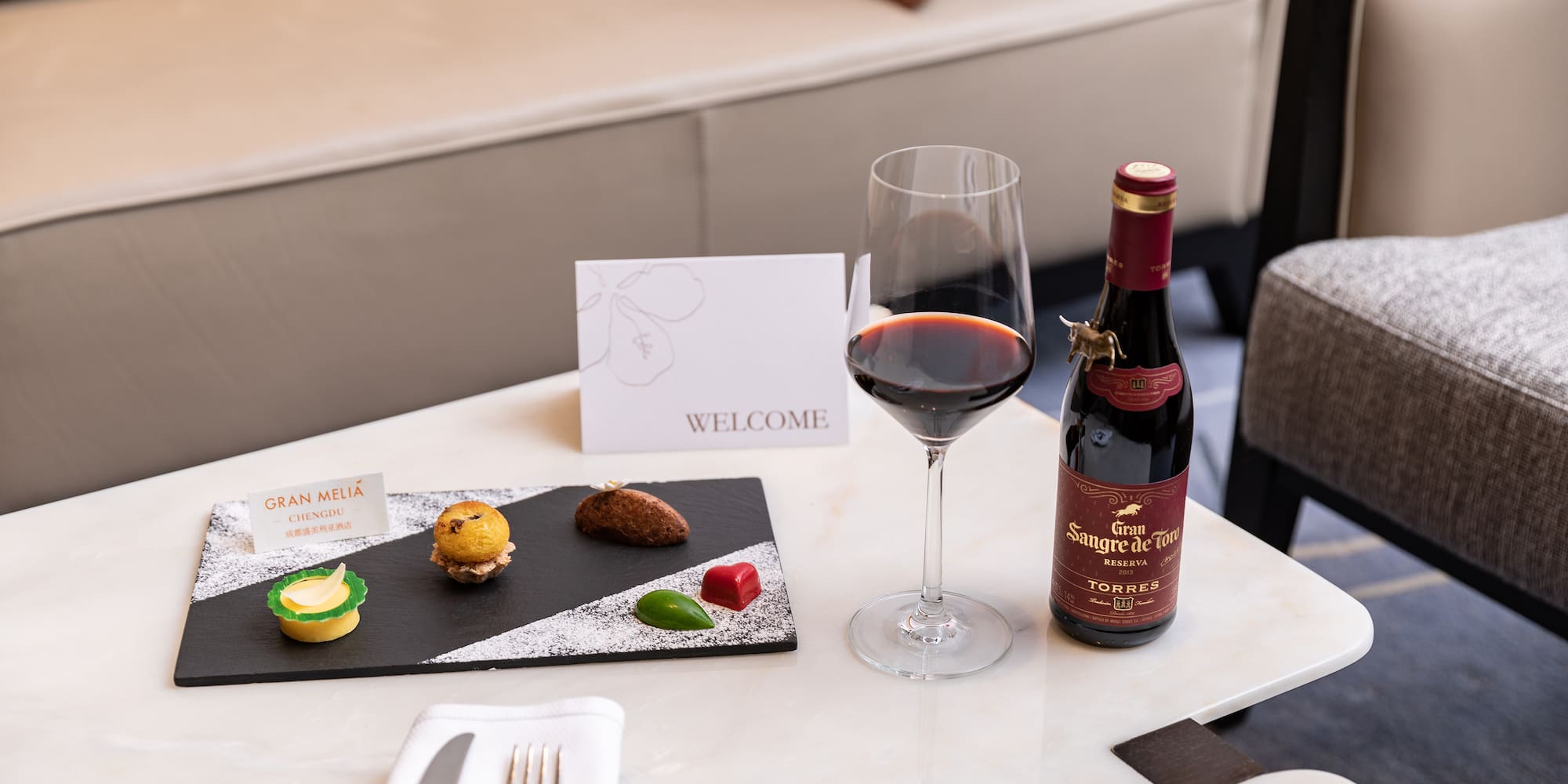 a wine bottle and a plate of food on a table