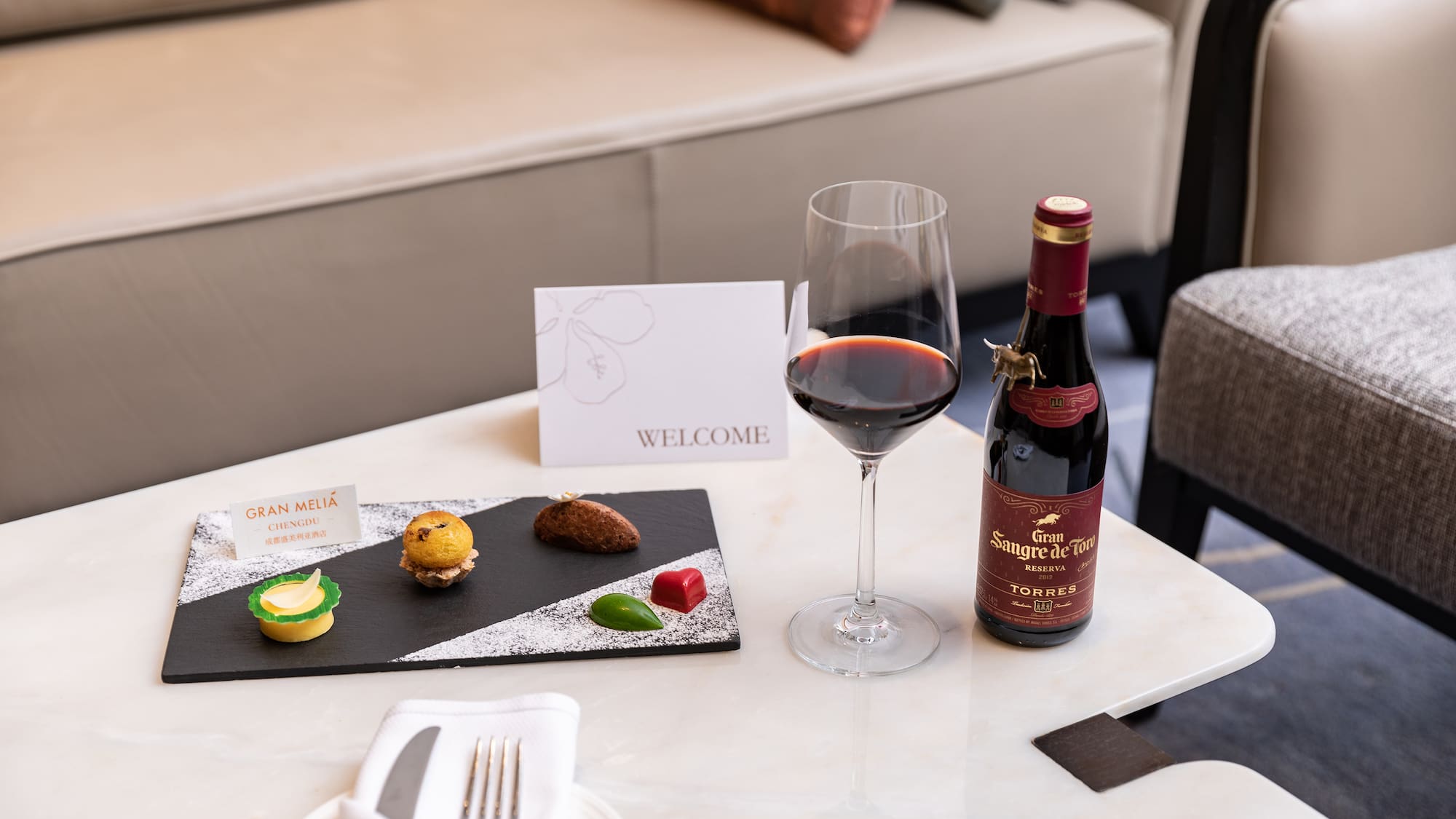 a wine bottle and a plate of food on a table