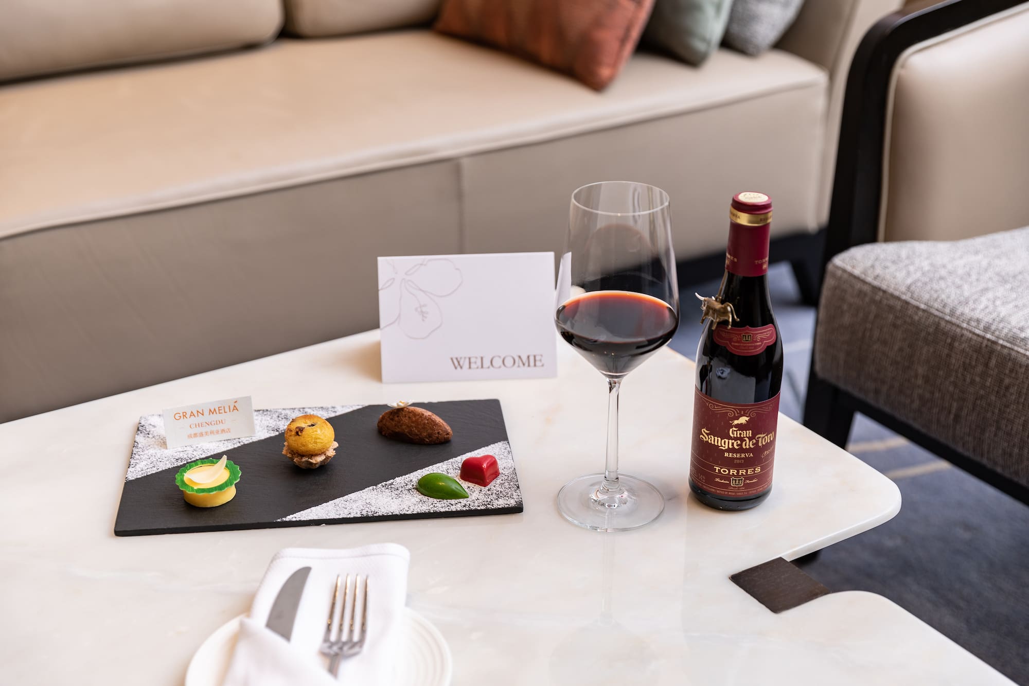 a wine bottle and a plate of food on a table