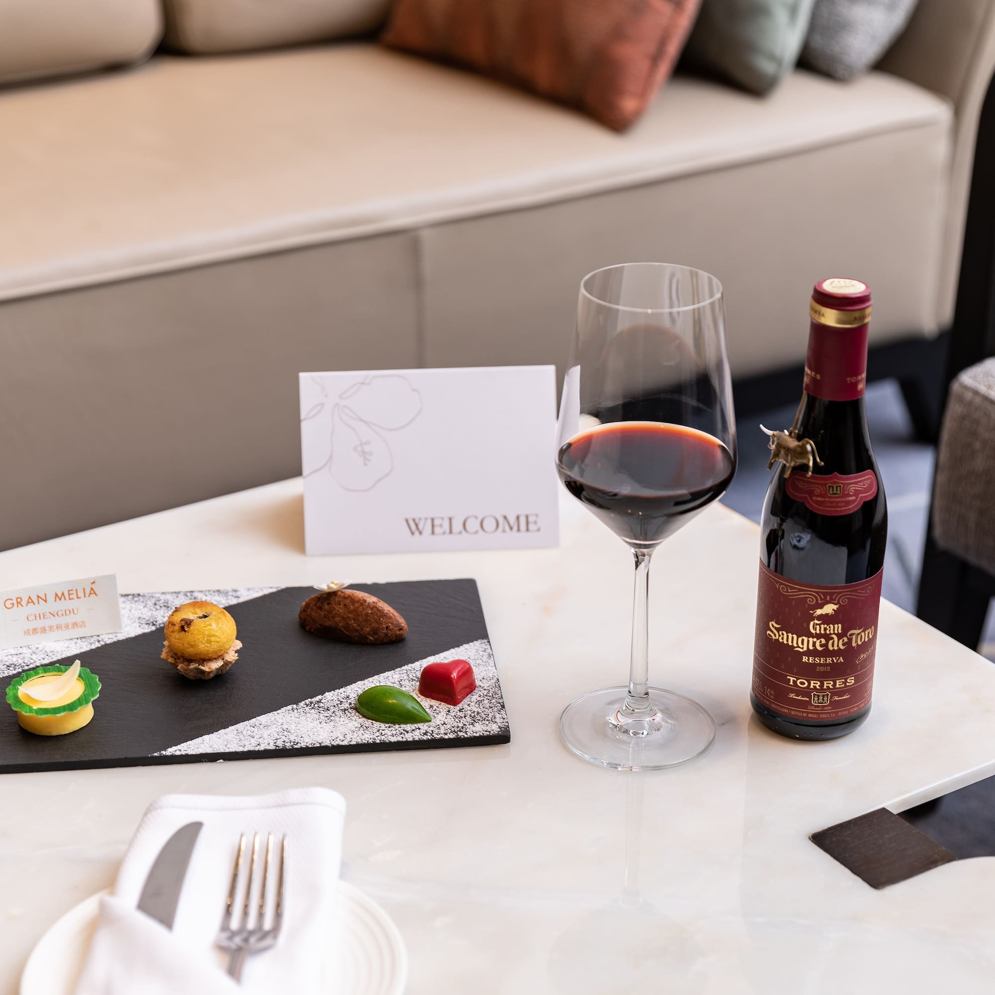 a wine bottle and a plate of food on a table