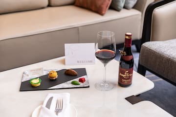a wine bottle and a plate of food on a table