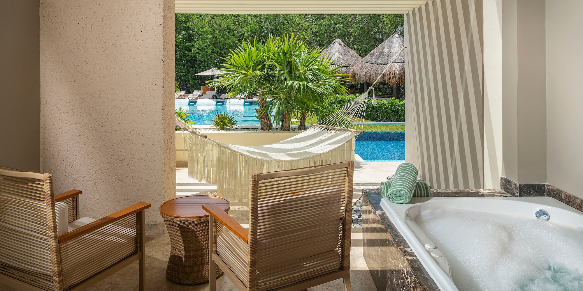a chair and a bathtub next to a pool