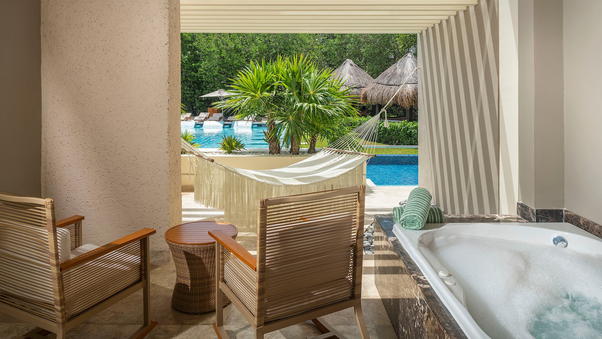 a chair and a bathtub next to a pool