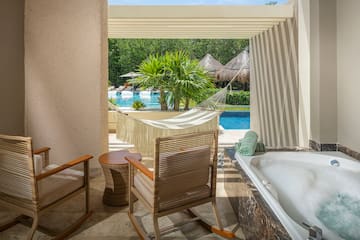a chair and a bathtub next to a pool