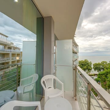 a balcony with chairs and a table