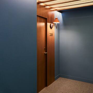 a door with a light on the wall