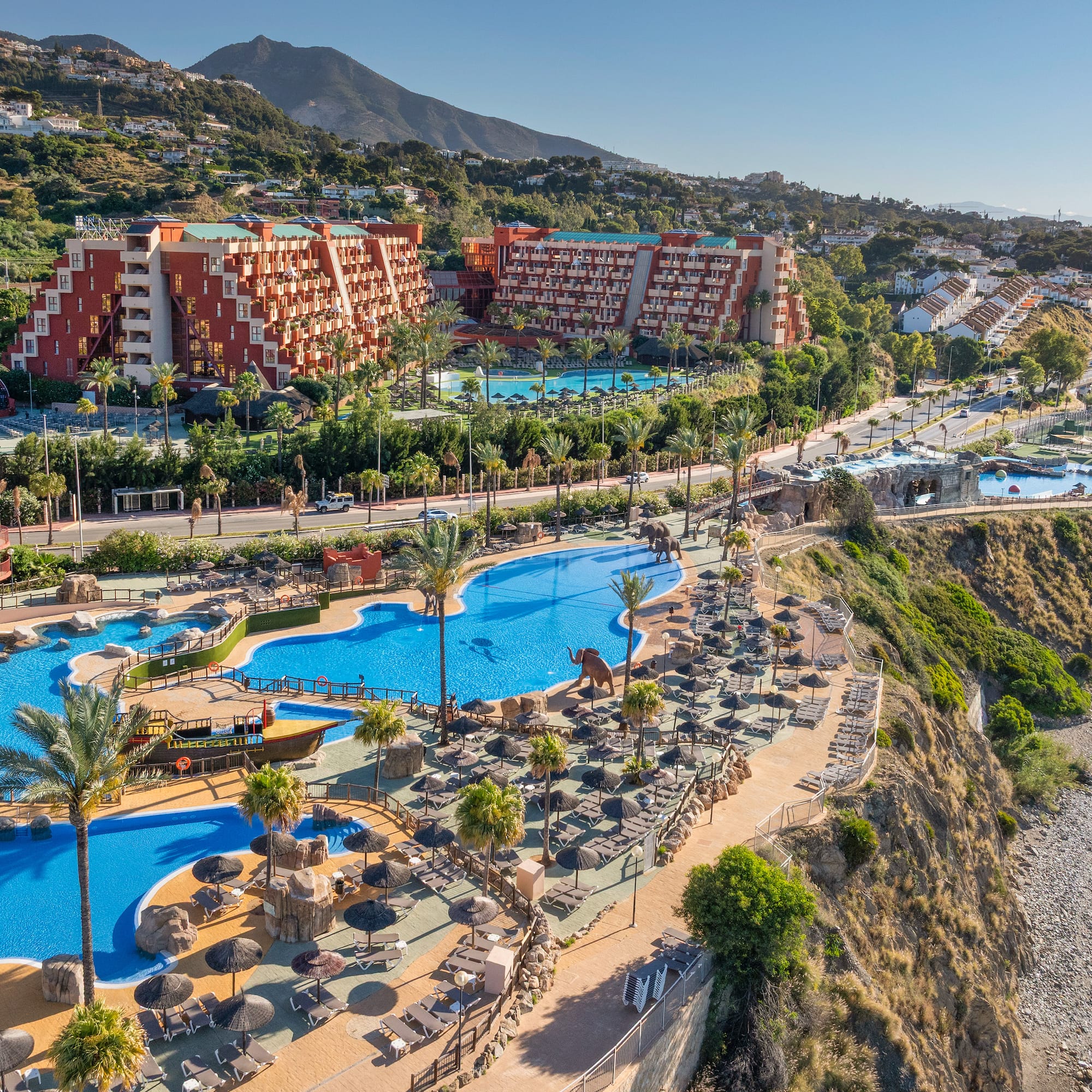 a large pool with a boat and a water slide