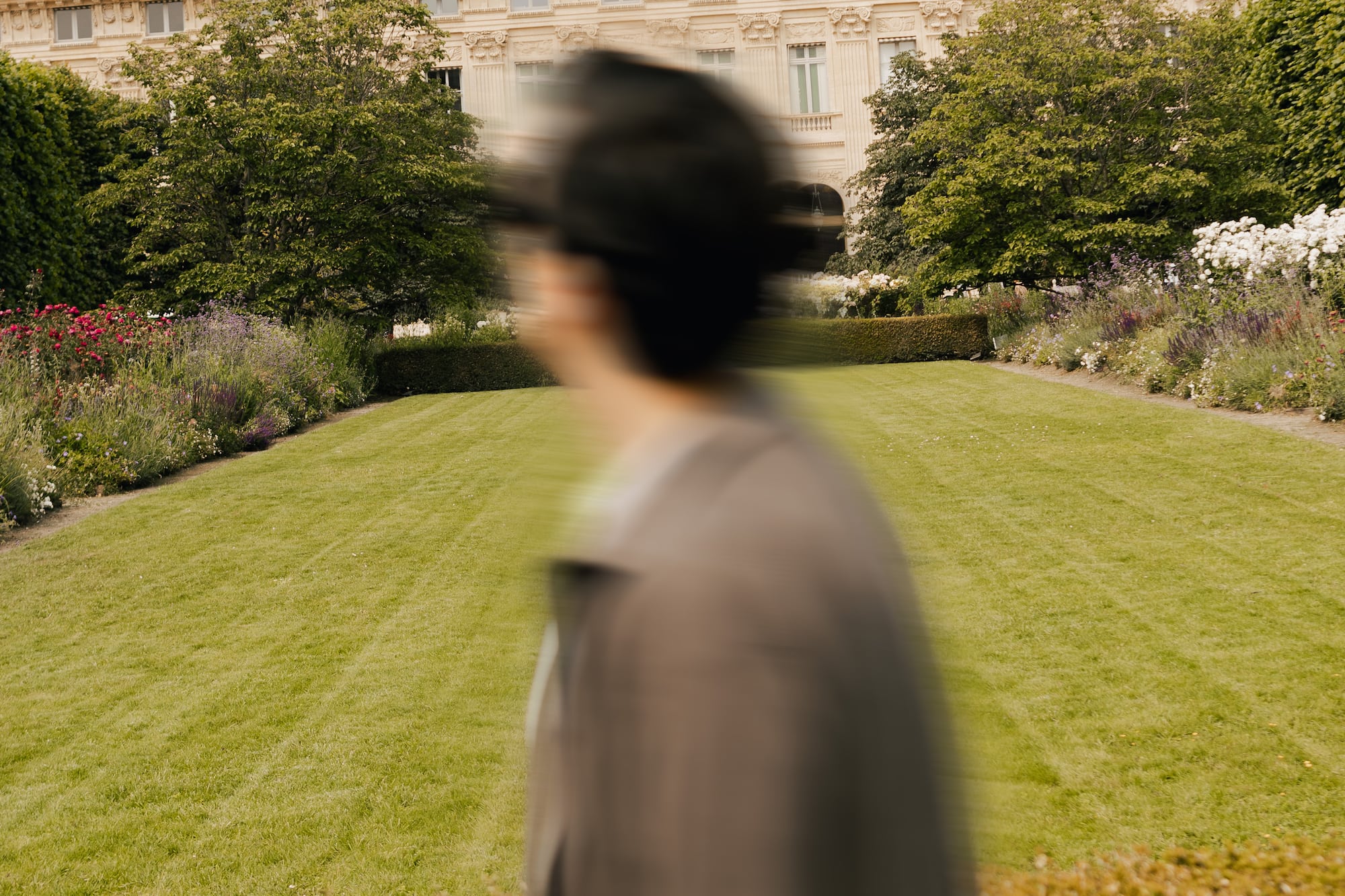 a blurry image of a person walking in a garden