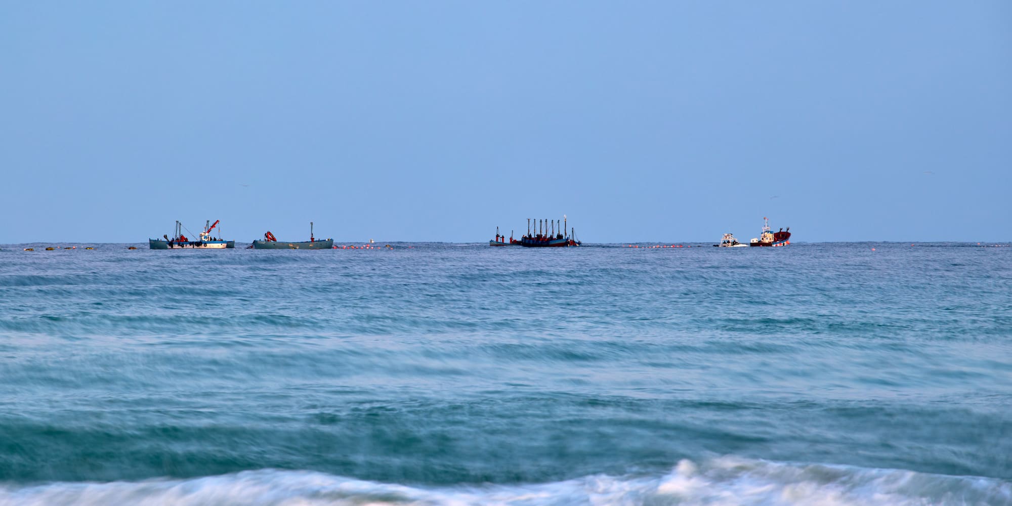 a group of boats in the ocean
