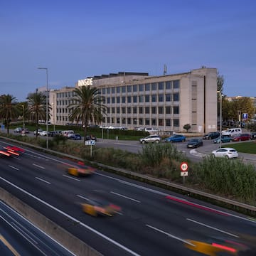 a large building with cars on the road