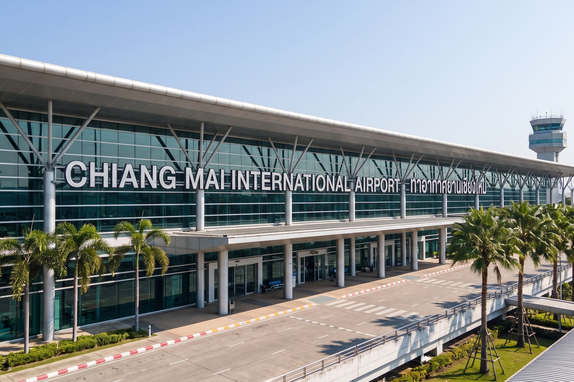 Chiang Mai International Airport terminal, palm trees, and control tower.