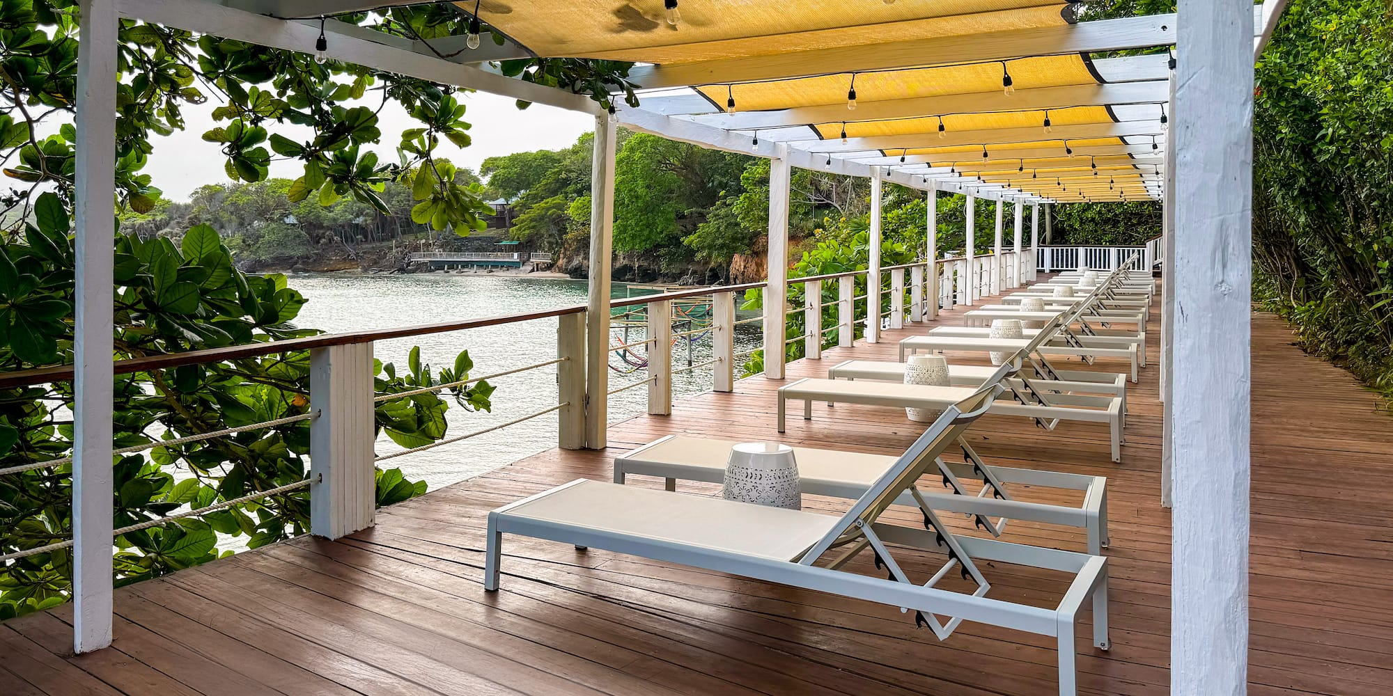 a deck with chairs and a canopy over it