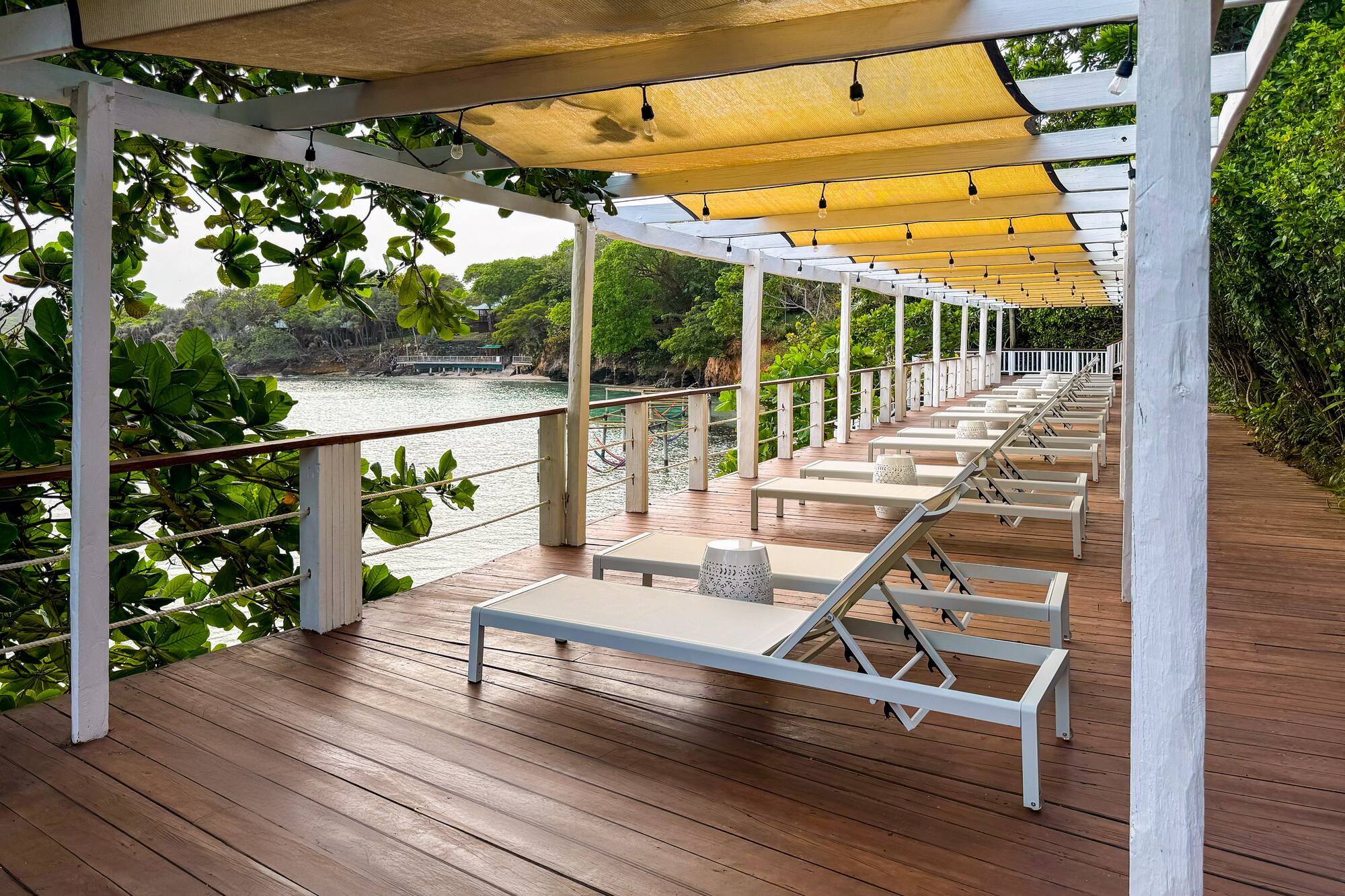 a deck with chairs and a canopy over it