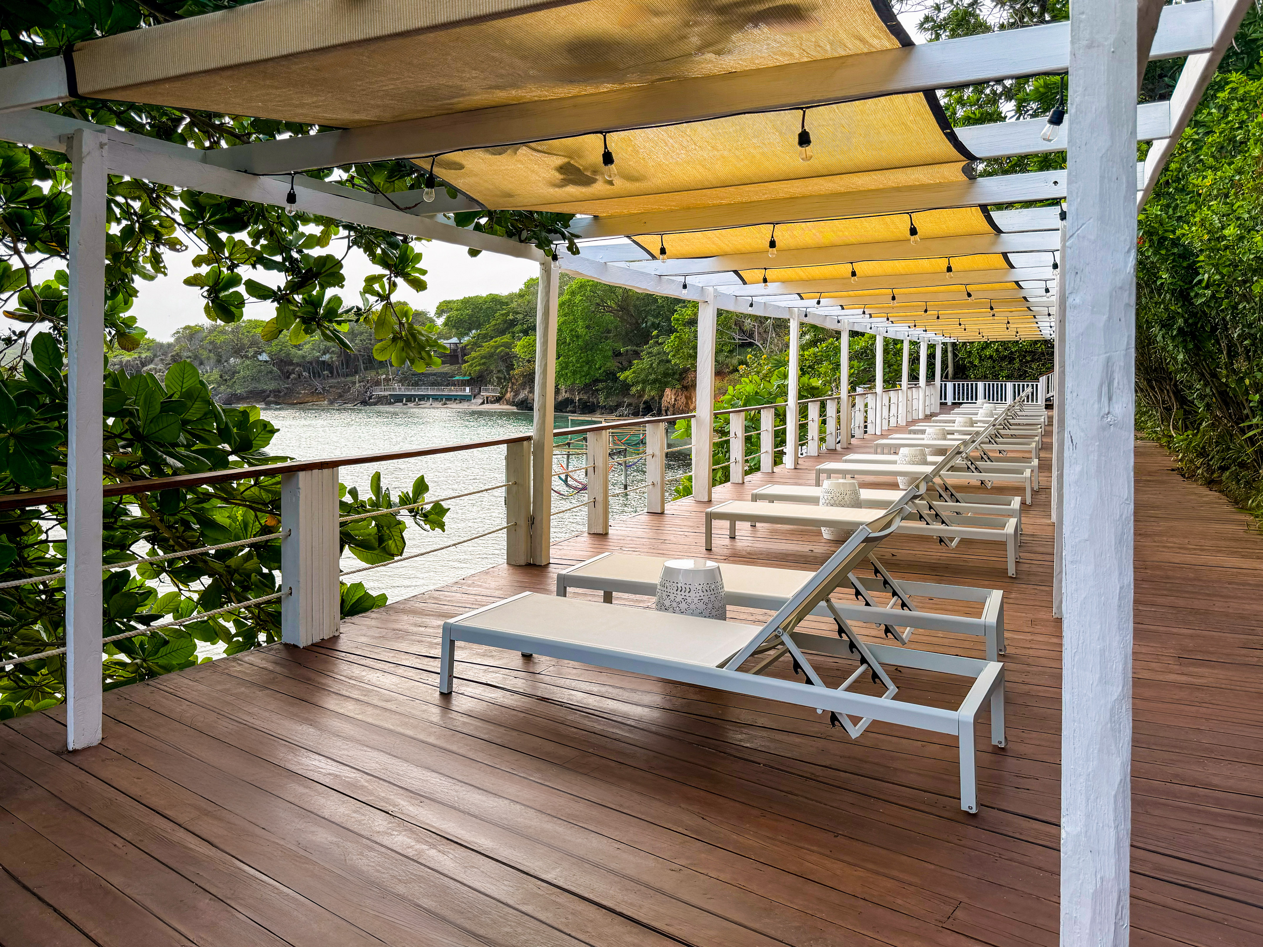 a deck with chairs and a canopy over it