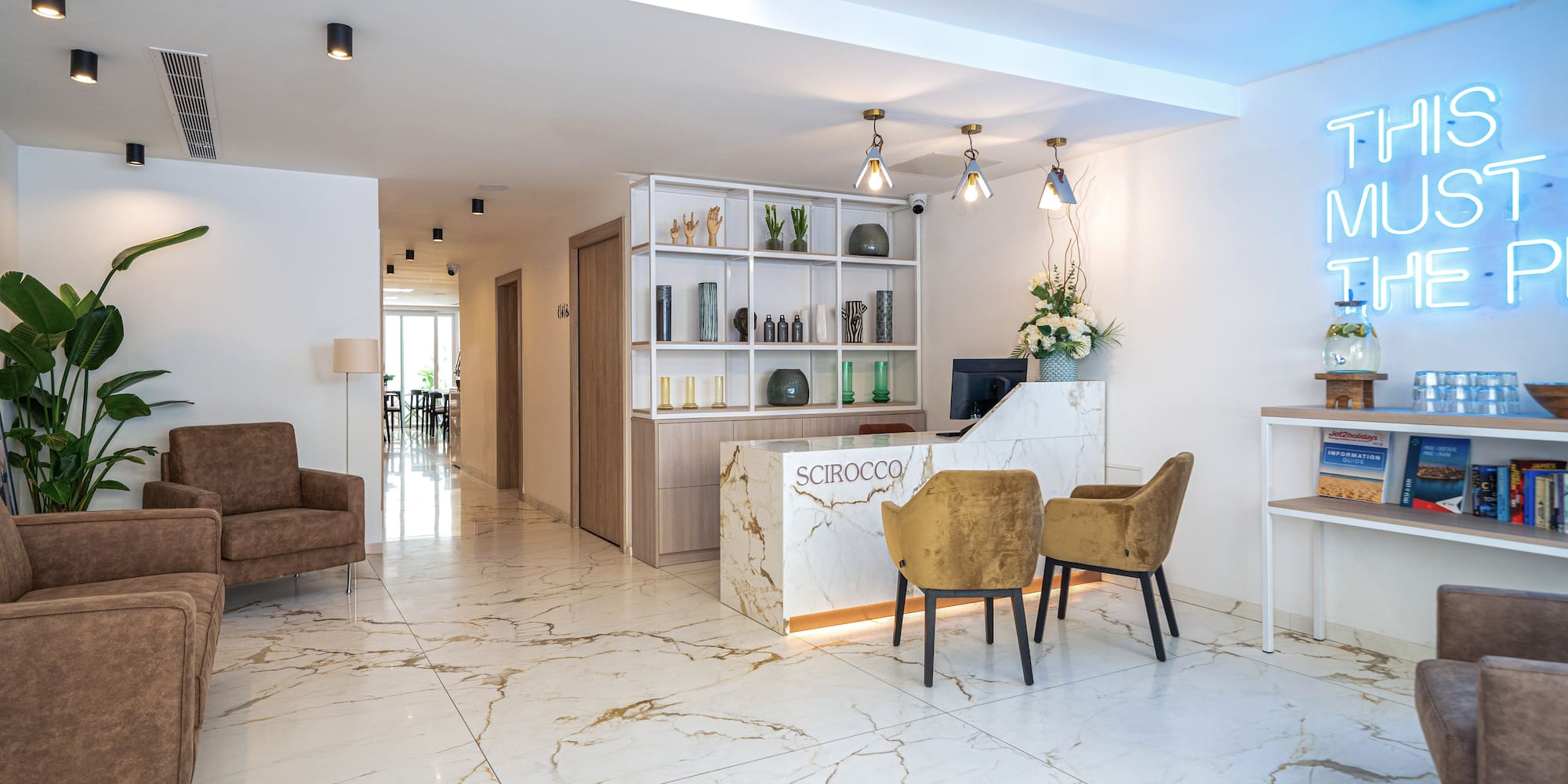 a room with a reception desk and chairs