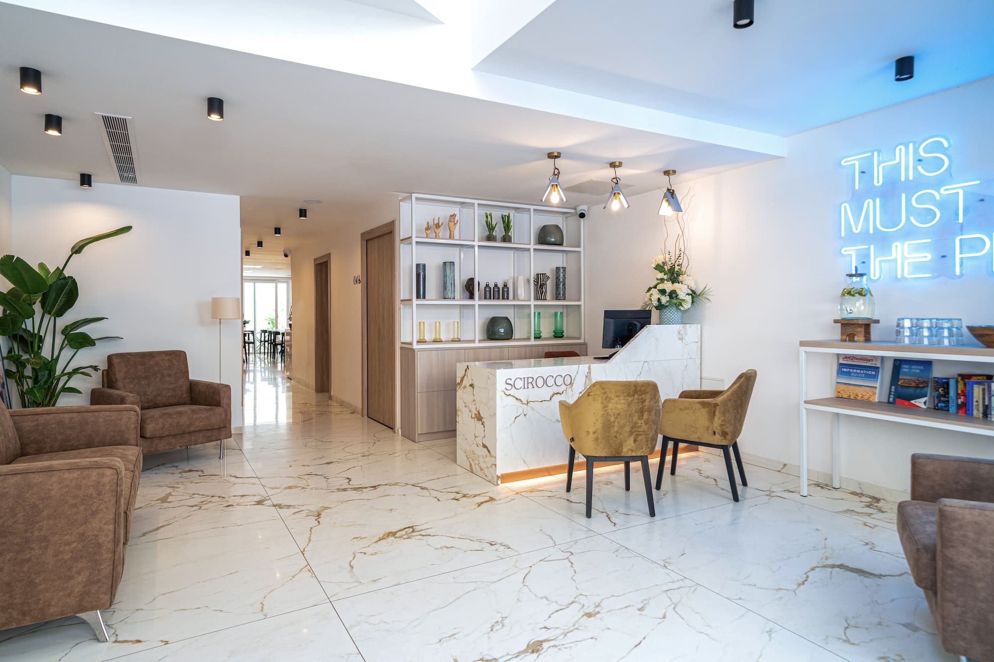a room with a reception desk and chairs