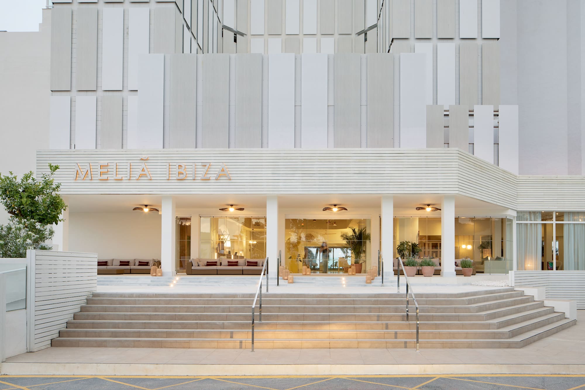 Meliá Ibiza hotel entrance, modern white facade, wide steps.