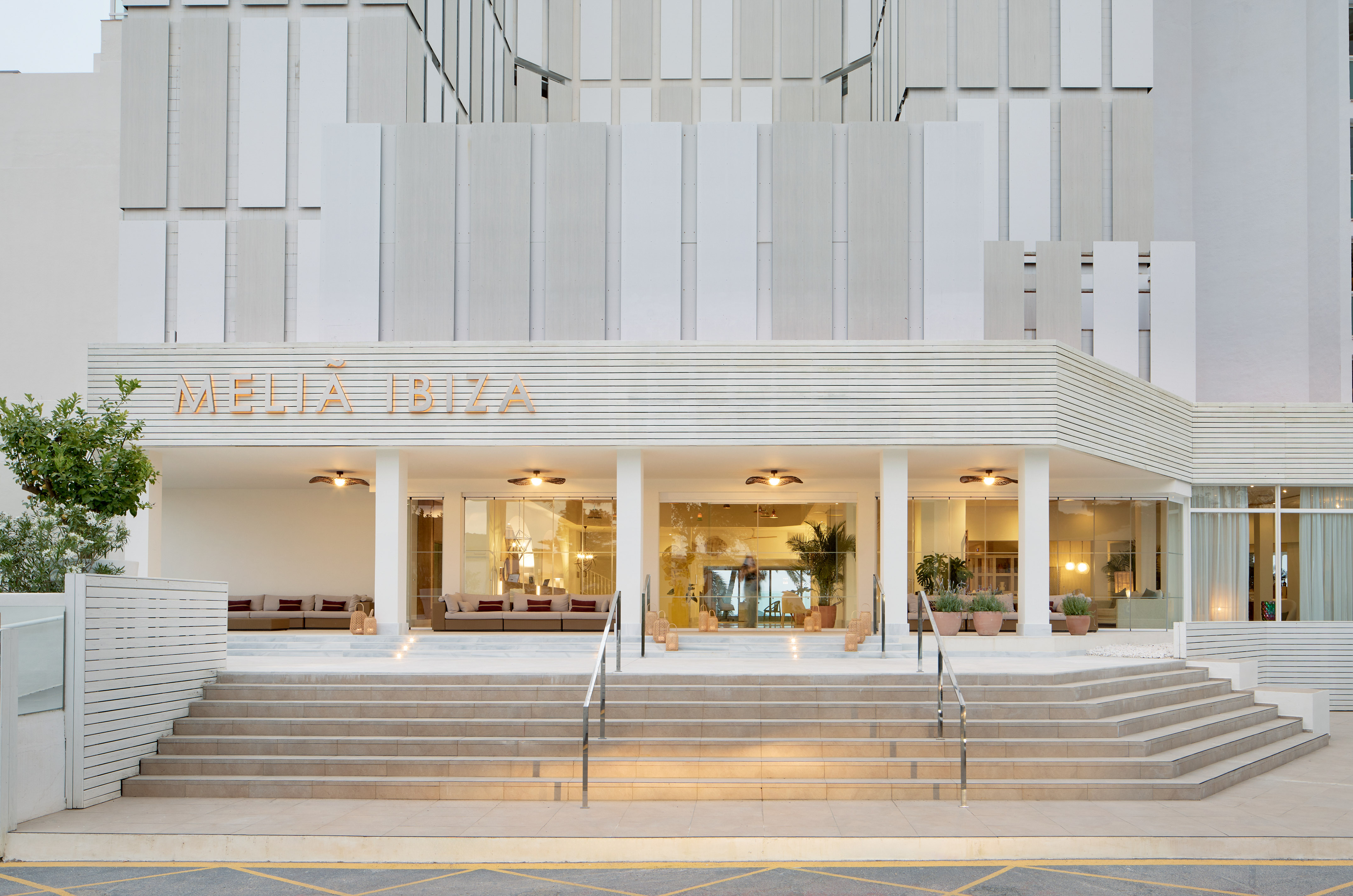 Meliá Ibiza hotel entrance, modern white facade, wide steps.